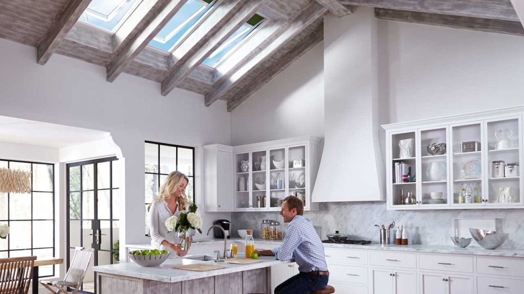 Man and woman in kitchen with skylights,