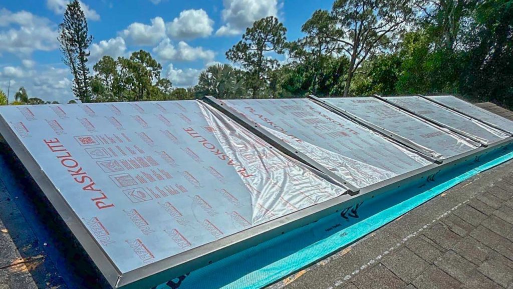 American Skylights custom ridge-mount skylight installation with protective film on a Florida roof.