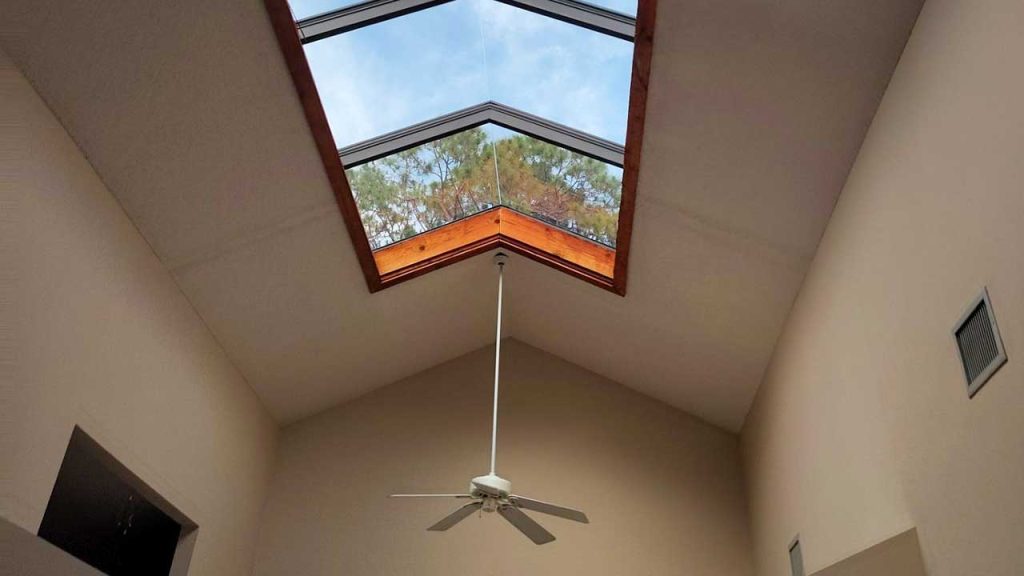 Interior view of an installed American Skylights ridge-mount skylight unit on a vaulted ceiling in Florida.
