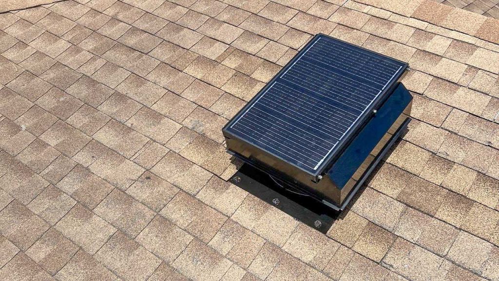 Completed installation of an Attic Breeze SFA-4523A self-flashing solar attic fan secured and flashed on an asphalt shingle roof.